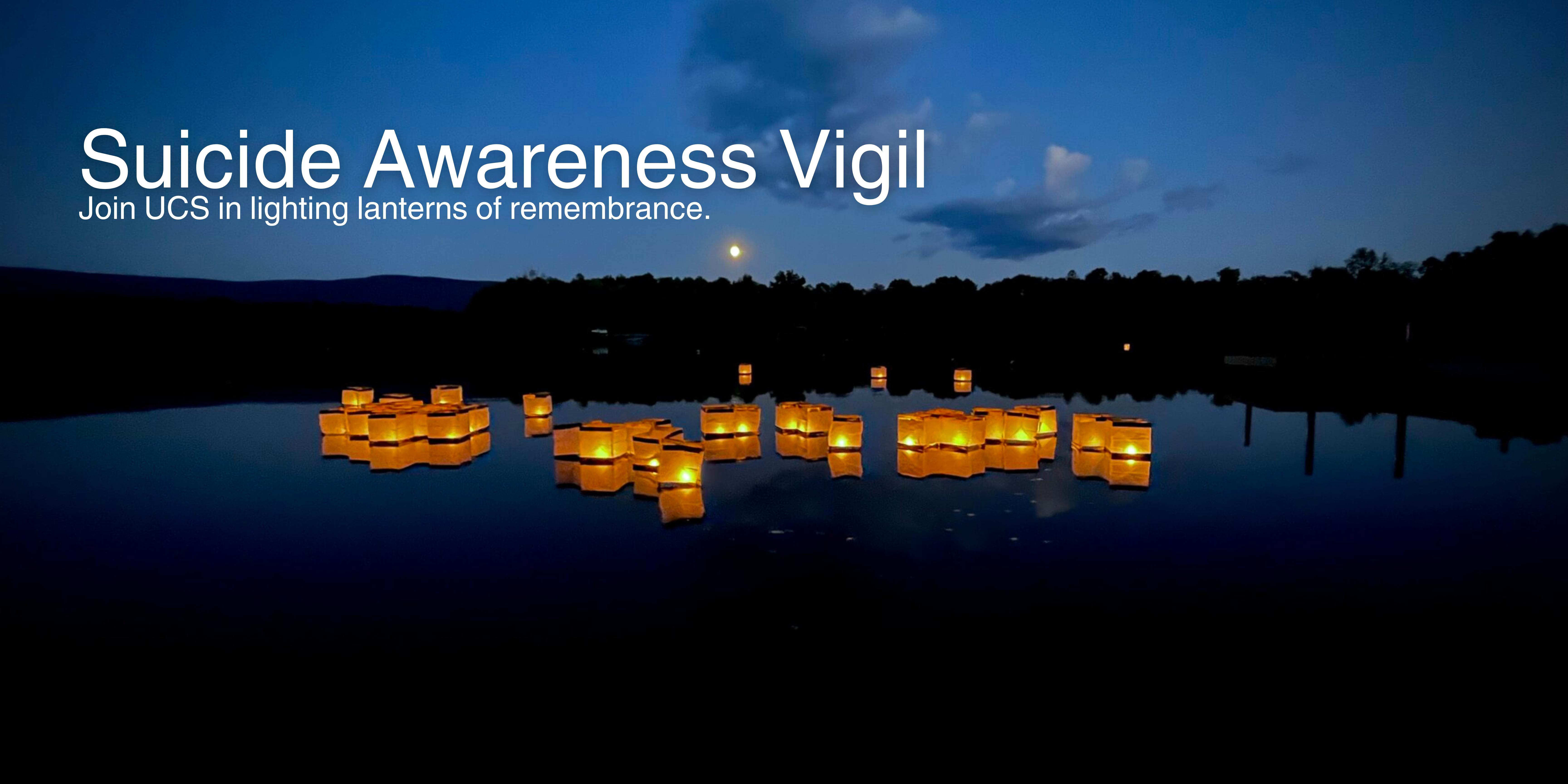 Glowing floating lanterns on a dark water with a dark blue sky with the text "Suicide Awareness Vigil. Join UCS in lighting lanterns of remembrance."